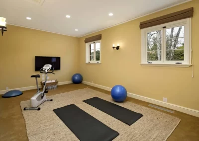 gym with exercise bike and yoga mats